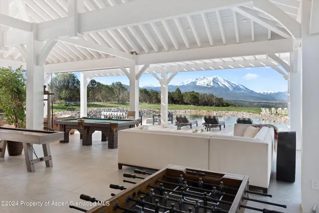 a view of a swimming pool and outdoor seating