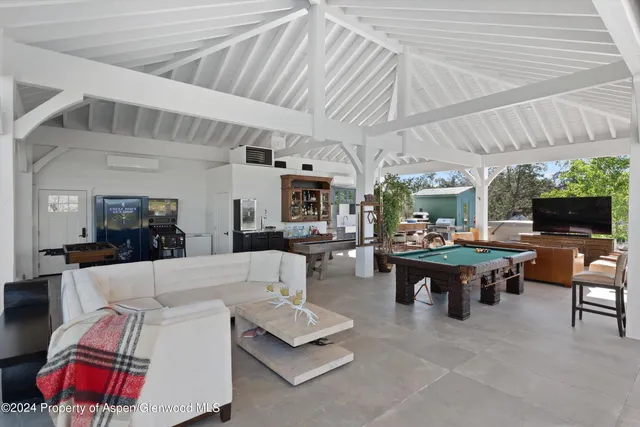 a living room with furniture and a floor to ceiling window