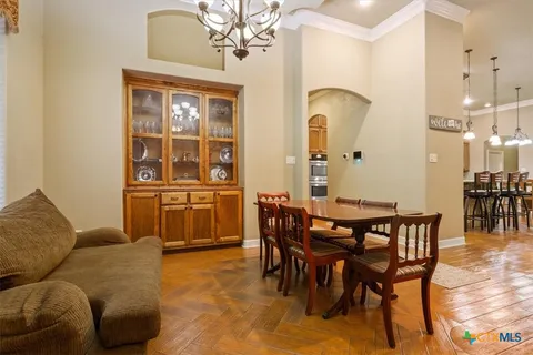 a living room with furniture a table and kitchen view