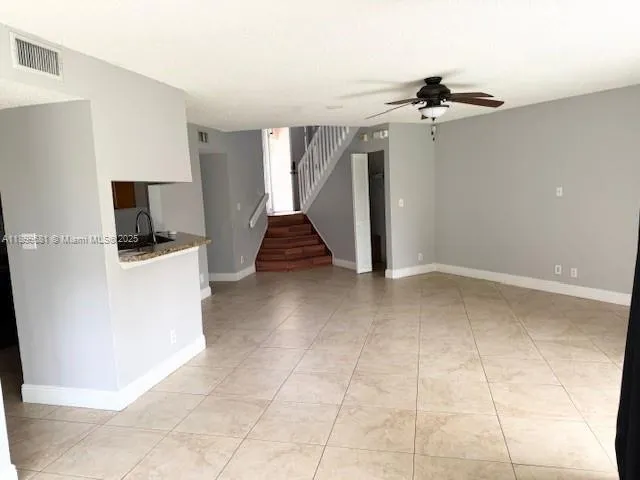a view of a kitchen with closet and a ceiling fan