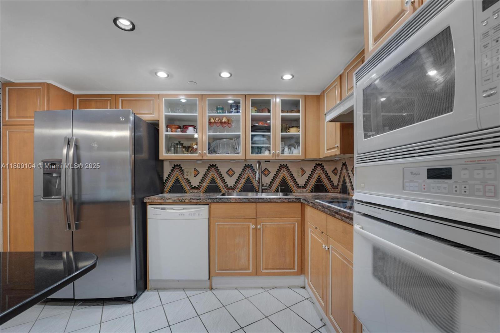 4000 Towerside Terrace, Unit 1403 Miami, FL 33138 - Photo 18 of 59 a kitchen with stainless steel appliances granite countertop a sink and a refrigerator