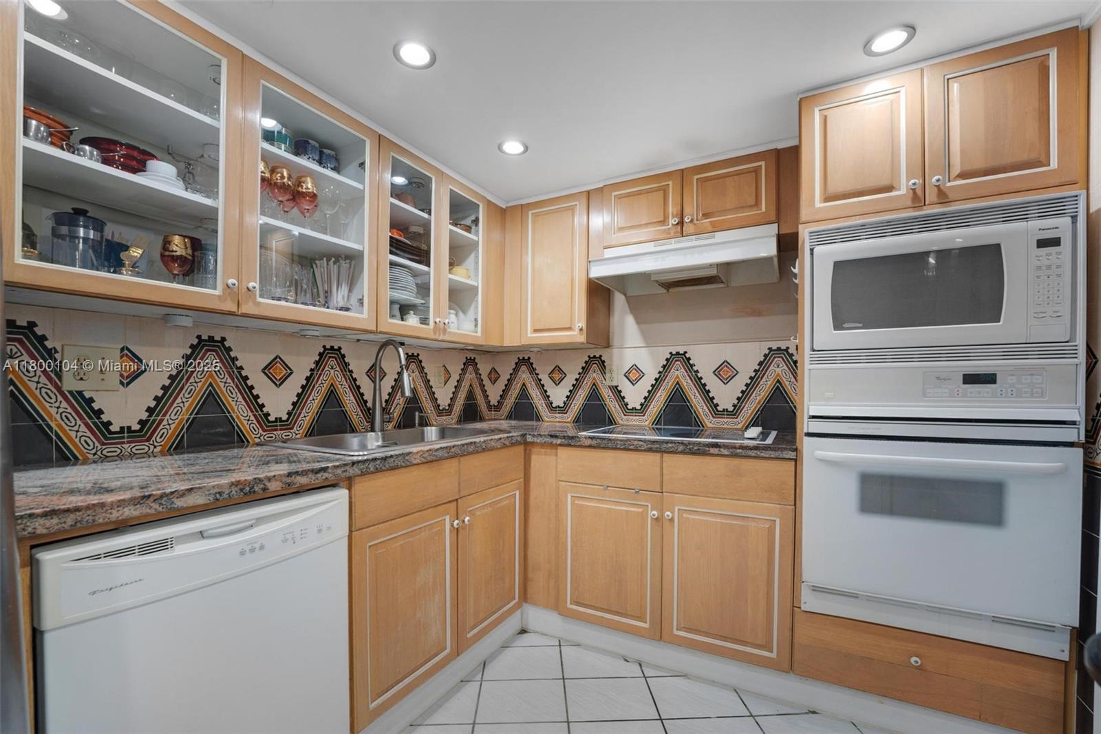 4000 Towerside Terrace, Unit 1403 Miami, FL 33138 - Photo 19 of 59 a kitchen with stainless steel appliances granite countertop a sink and cabinets