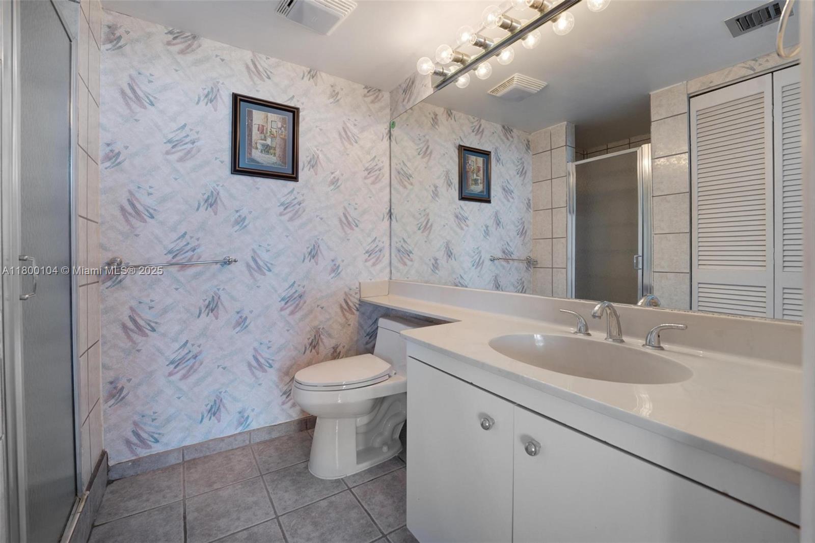 4000 Towerside Terrace, Unit 1403 Miami, FL 33138 - Photo 24 of 59 a bathroom with a toilet sink and mirror