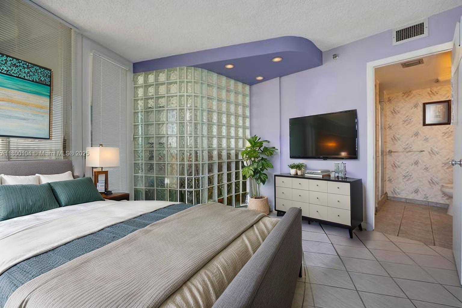 4000 Towerside Terrace, Unit 1403 Miami, FL 33138 - Photo 25 of 59 a bedroom with a bed and a flat screen tv