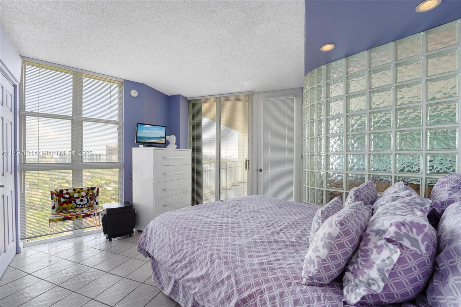 4000 Towerside Terrace, Unit 1403 Miami, FL 33138 - Photo 27 of 59 a bed sitting in a spacious bedroom next to a large window