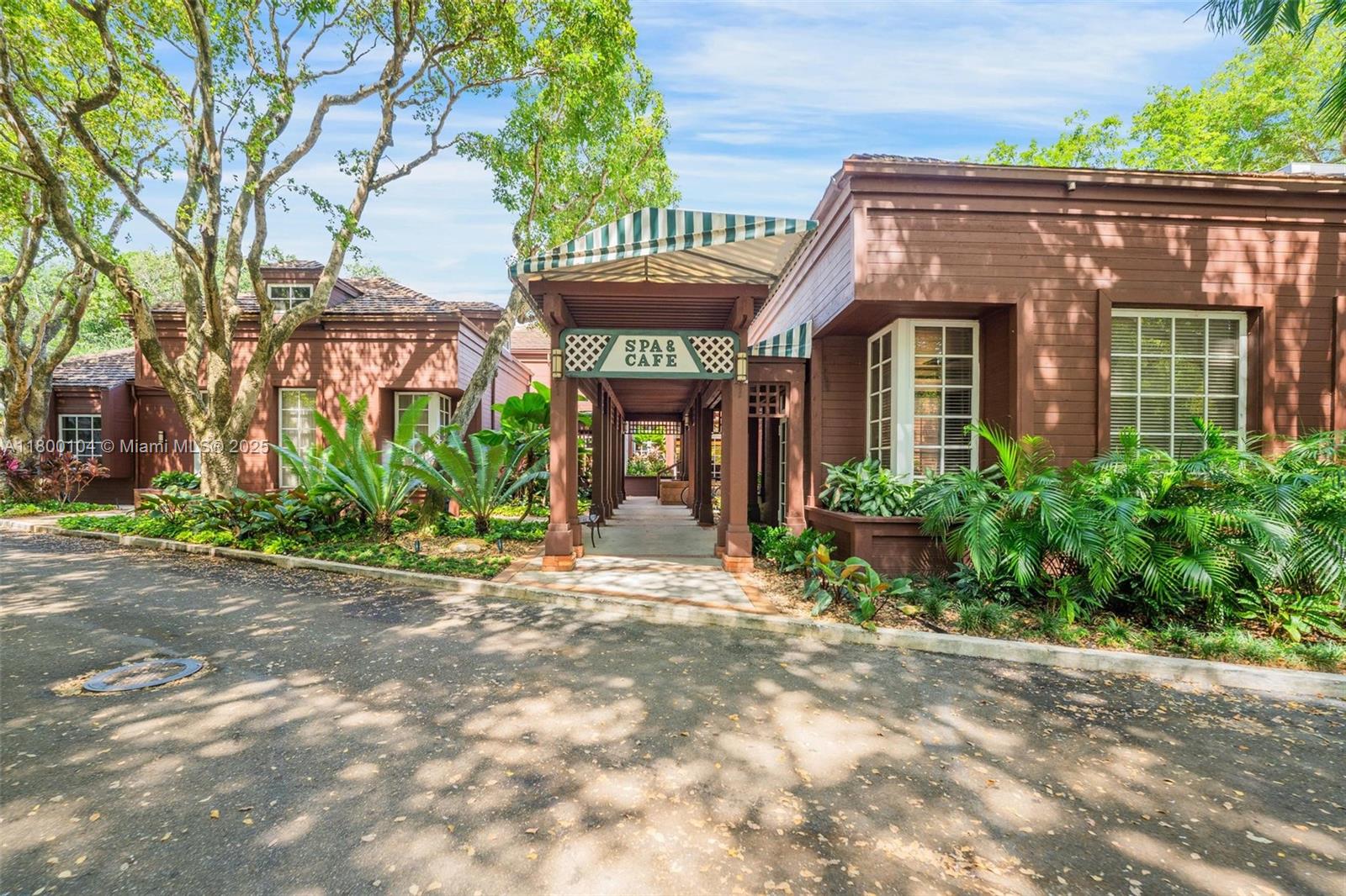 4000 Towerside Terrace, Unit 1403 Miami, FL 33138 - Photo 33 of 59 a view of a house with brick walls plants and large tree