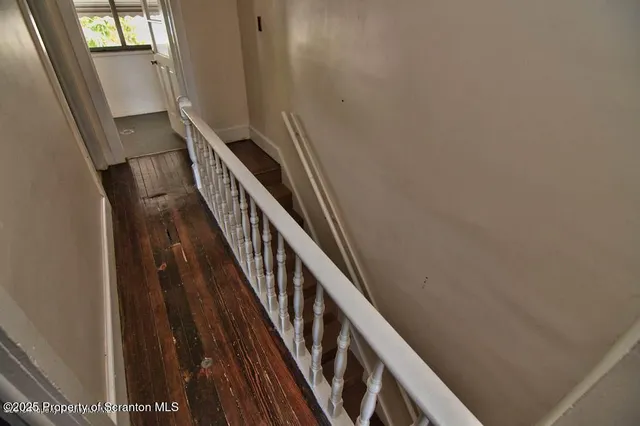 a view of an entryway with wooden floor