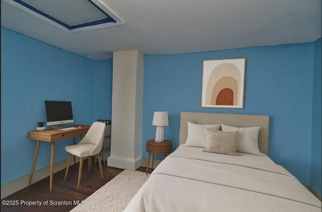 a bedroom with a bed and a chair