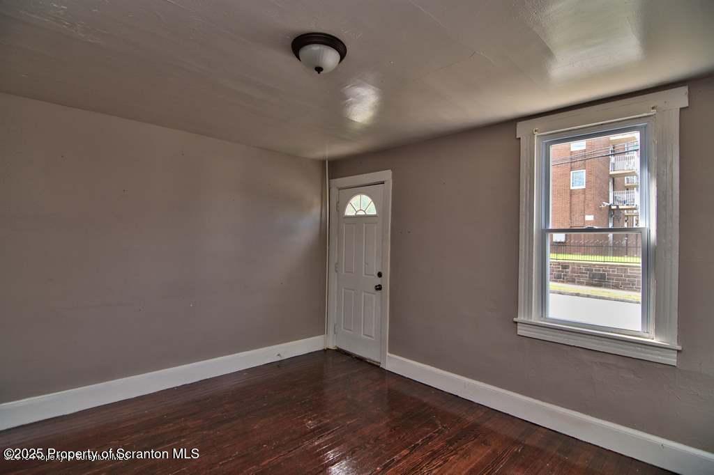 18 Pine Road Wilkes Barre, PA 18705 - Photo 22 of 33 an empty room with wooden floor and windows