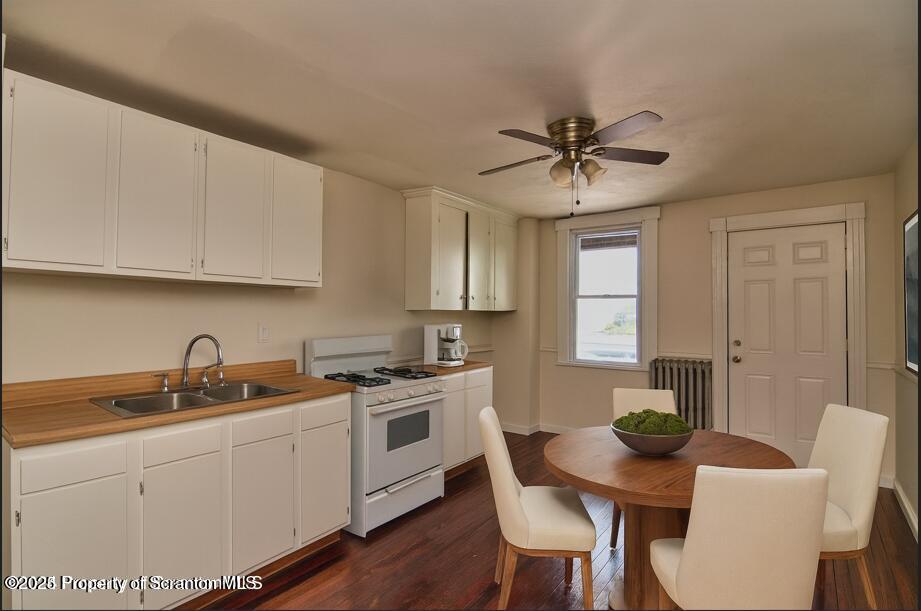 18 Pine Road Wilkes Barre, PA 18705 - Photo 25 of 32 a kitchen with a stove a sink a dining table and chairs