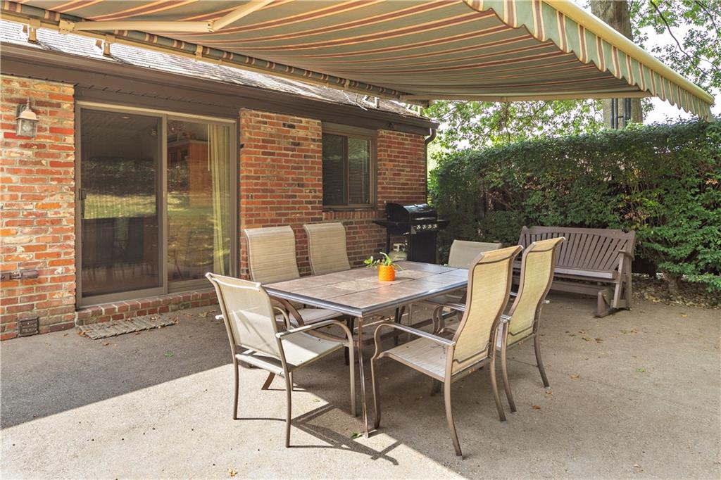 5896 Claridge Export Road Export, PA 15632 - Photo 4 of 25 Retractable Awning extends over the large concrete patio! Evening dinners out on the patio this fall will create the outdoor dining feel we all need these days while staying home!