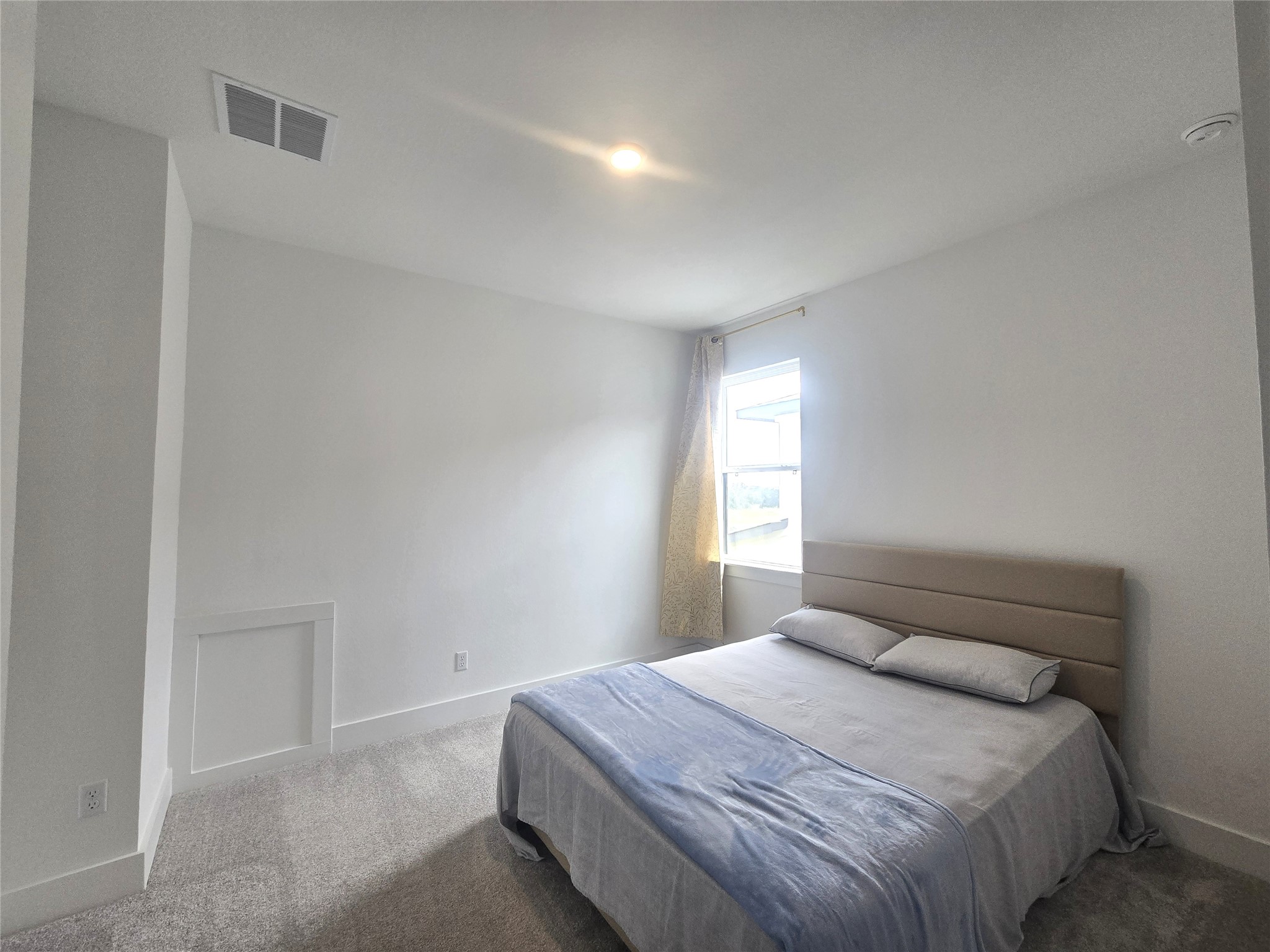 124 Ribera Drive Liberty Hill, TX 78642 - Photo 23 of 40 Sun-filled bedroom featuring soft carpeting, ideal for a comfortable retreat.
