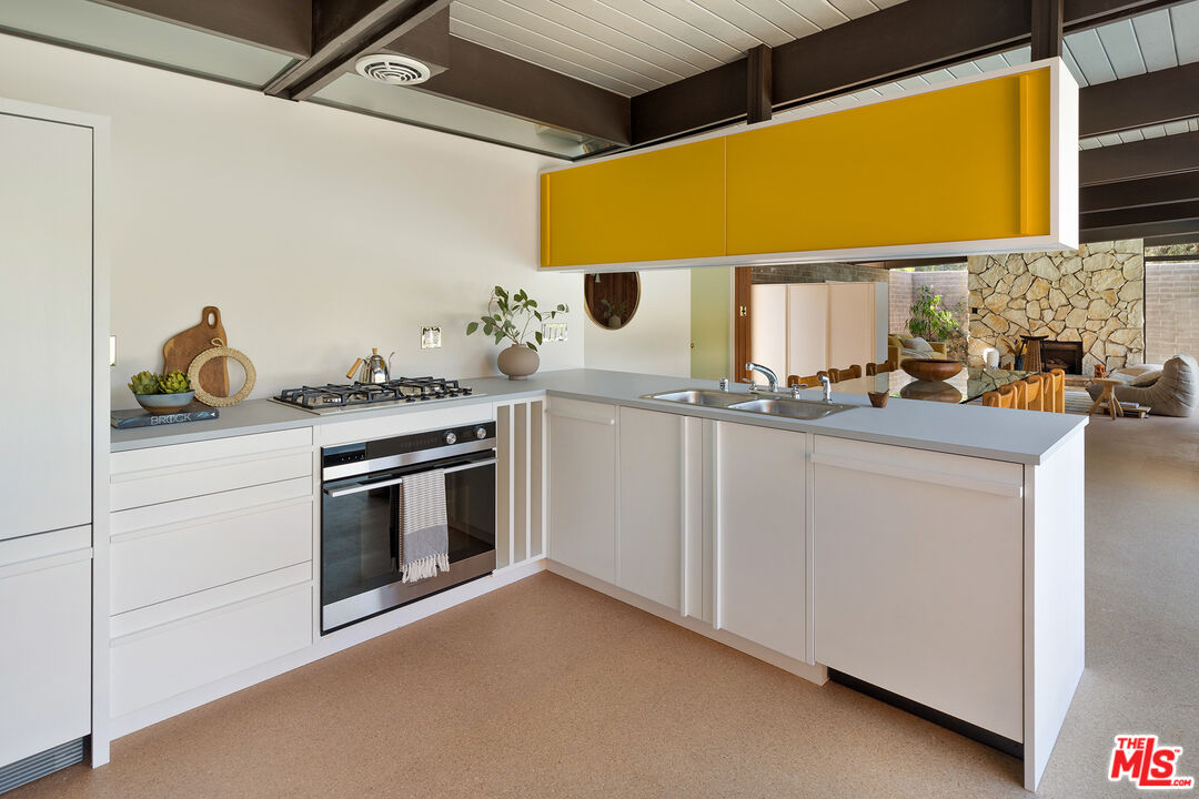 272 Mesa Lila Road Glendale, CA 91208 - Photo 11 of 46 a kitchen with stainless steel appliances granite countertop a sink and a stove