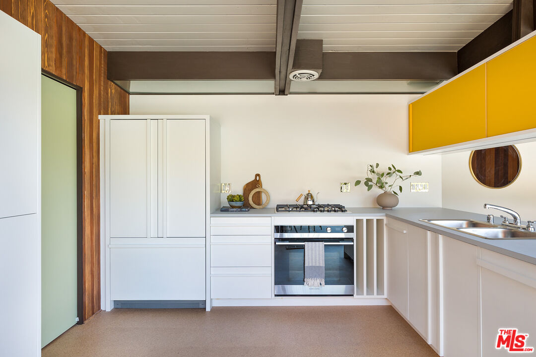 272 Mesa Lila Road Glendale, CA 91208 - Photo 12 of 46 a kitchen with a stove and a white cabinet