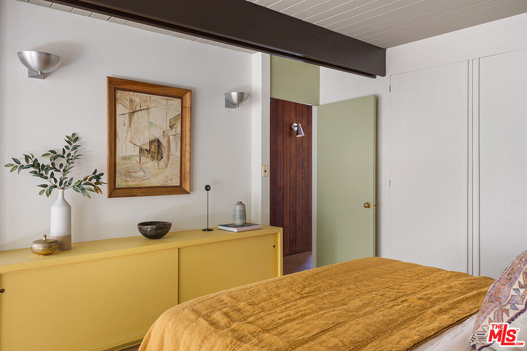 272 Mesa Lila Road Glendale, CA 91208 - Photo 30 of 46 a bedroom with a bed and a potted plant