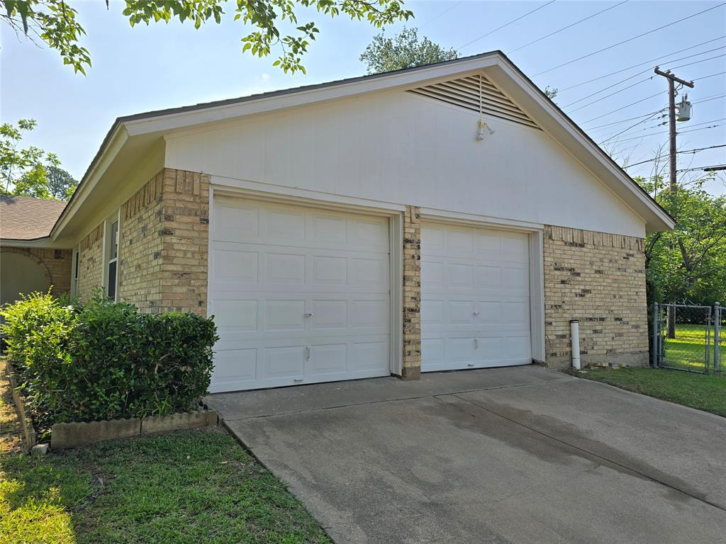 1000 Springdale Road Bedford, TX 76021 - Photo 36 of 36 Garage entry on Shady Brook Drive with access to the backyard. Make this your next home!