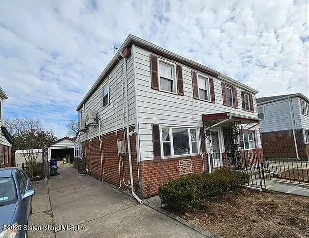 a front view of a house with garage