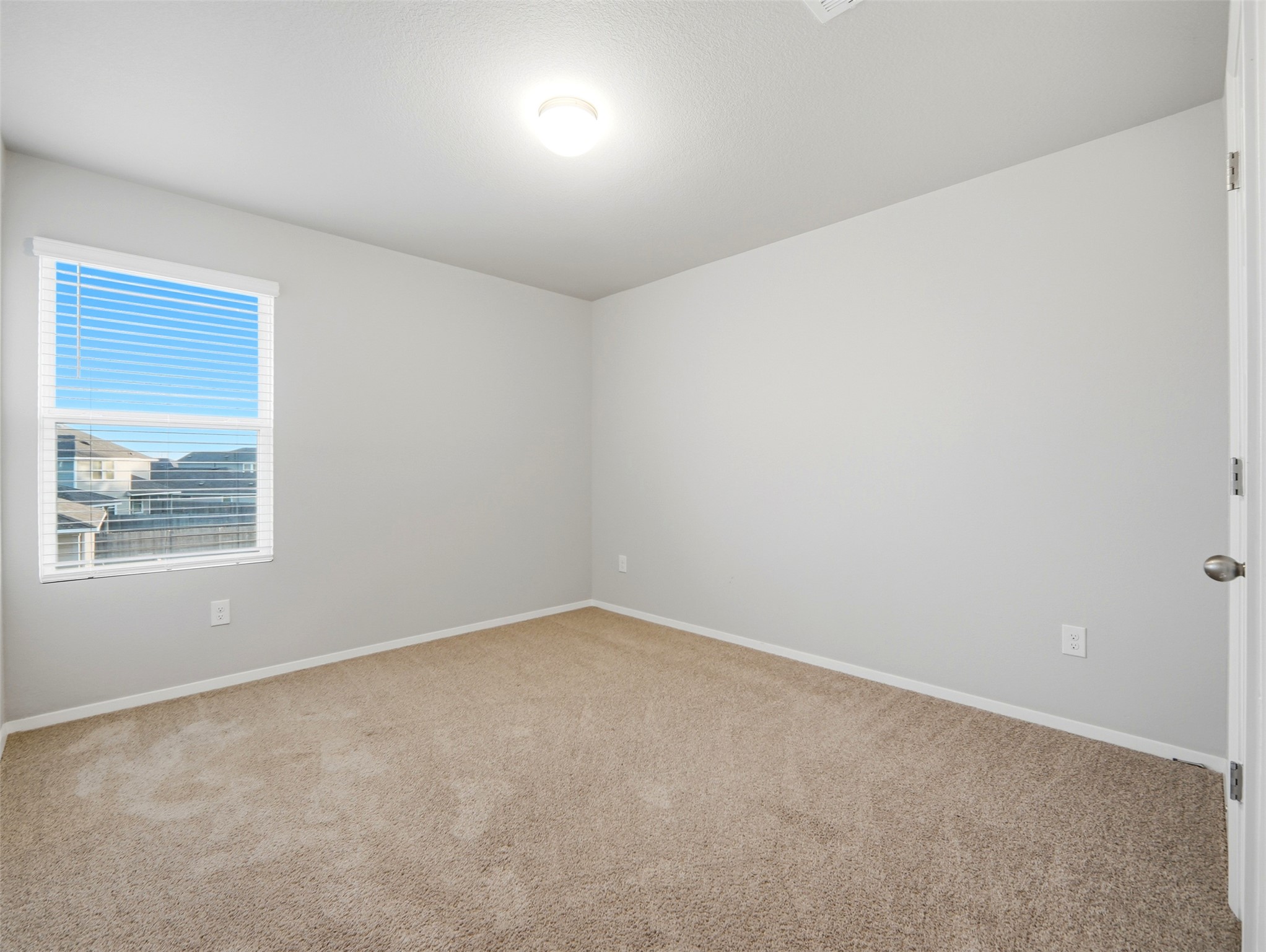 60 Bent Trl Lane Georgetown, TX 78628 - Photo 20 of 40 A well-lit bedroom provides ample natural light and plush carpeting.