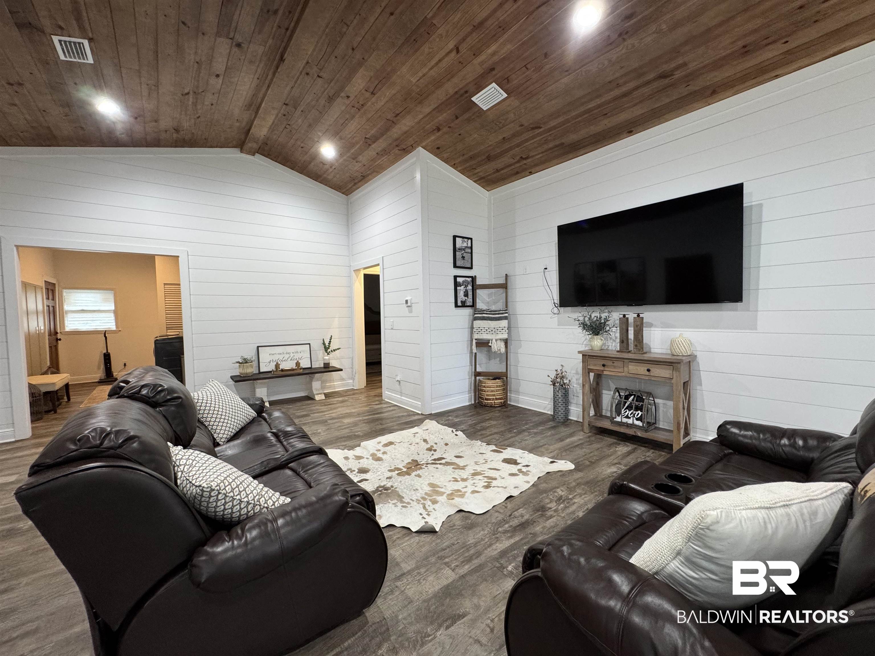 370 Dianne Road Frisco City, AL 36445 - Photo 25 of 41 Living room with wooden ceiling, dark hardwood / wood-style floors, wooden walls, and lofted ceiling
