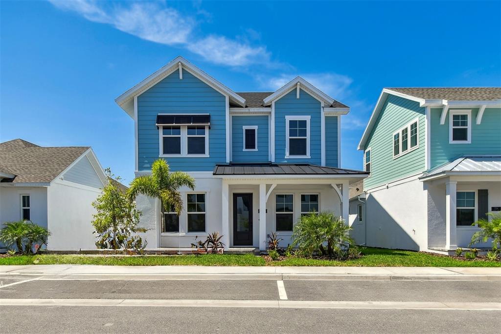 a front view of a house with a garden and plants