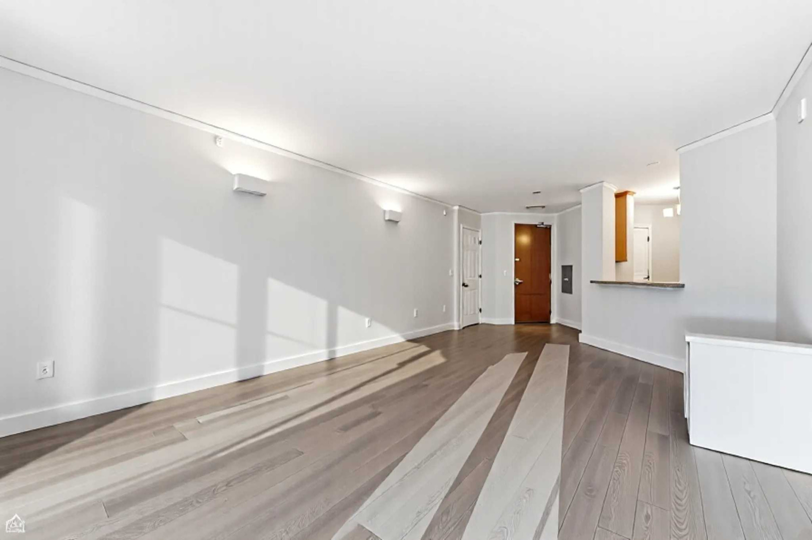 420 East Waterside Drive, Unit 1502 Chicago, IL 60601 - Photo 3 of 11 a view of an empty room with wooden floor and a window