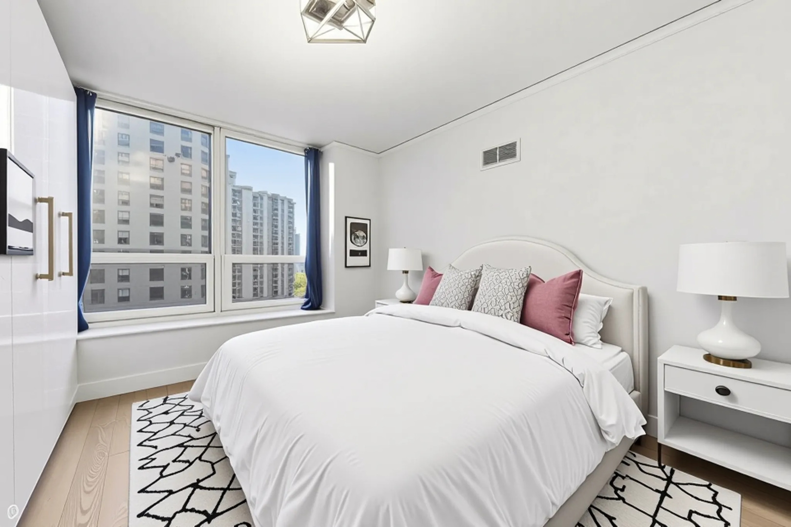 420 East Waterside Drive, Unit 1502 Chicago, IL 60601 - Photo 6 of 11 a spacious bedroom with a bed and a large window