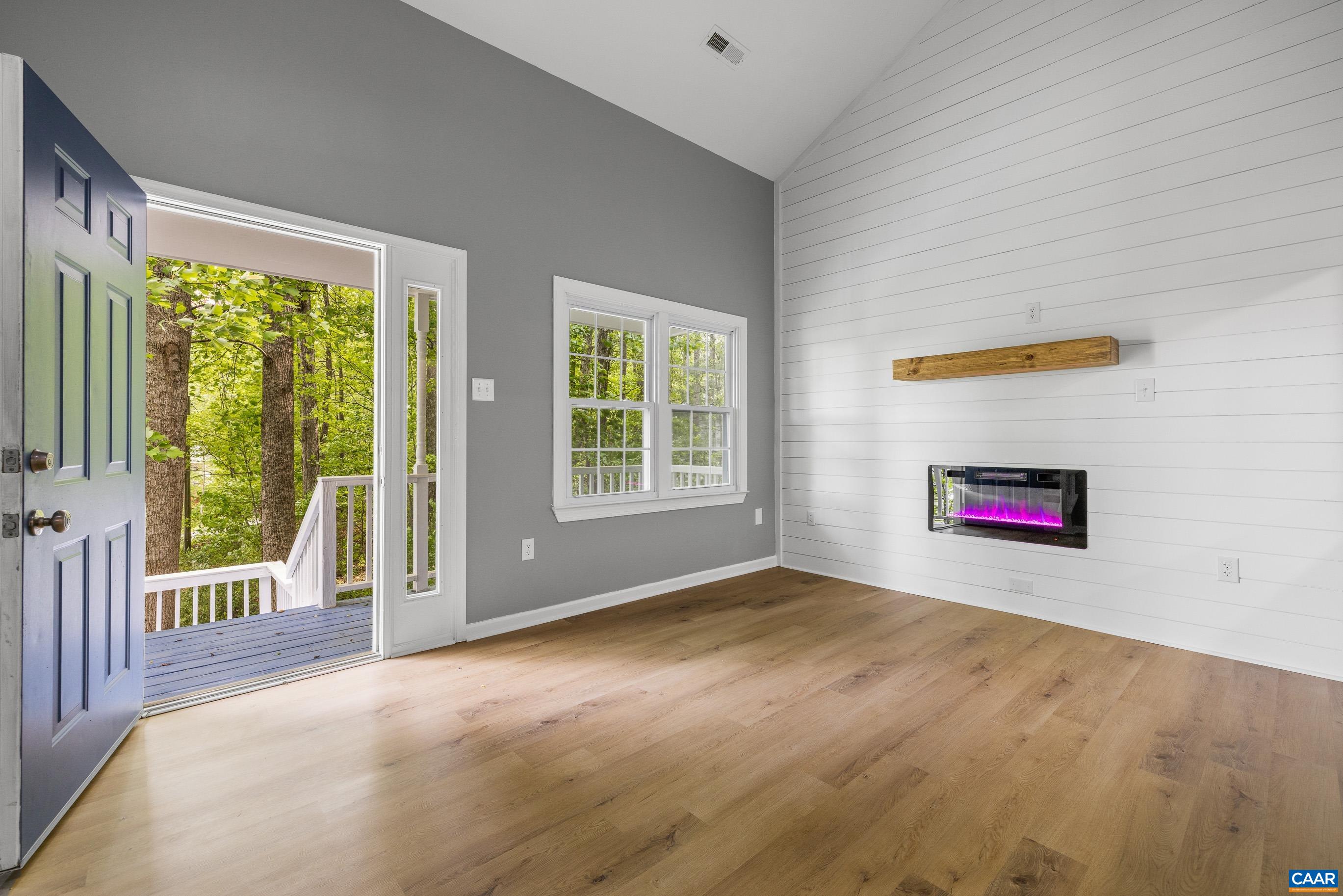 440 Carnation Road Ruckersville, VA 22968 - Photo 3 of 44 a view of an empty room with a window and wooden floor