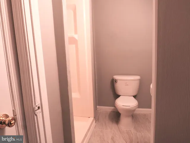 a bathroom with a shower curtain and a window