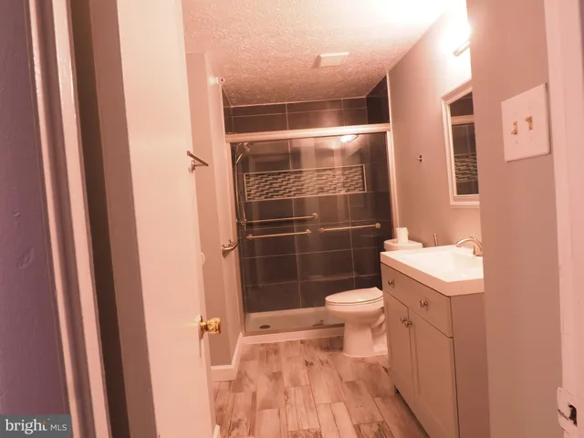 a bathroom with a toilet and a shower