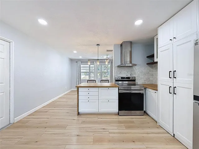 a kitchen with stainless steel appliances granite countertop a stove and a refrigerator