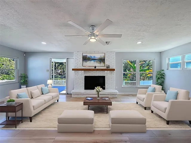 a living room with furniture fireplace and window