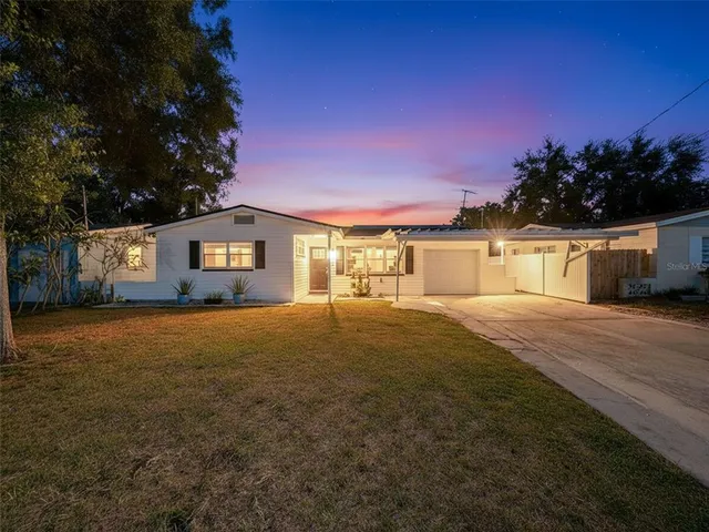 a front view of a house with a yard and a garage