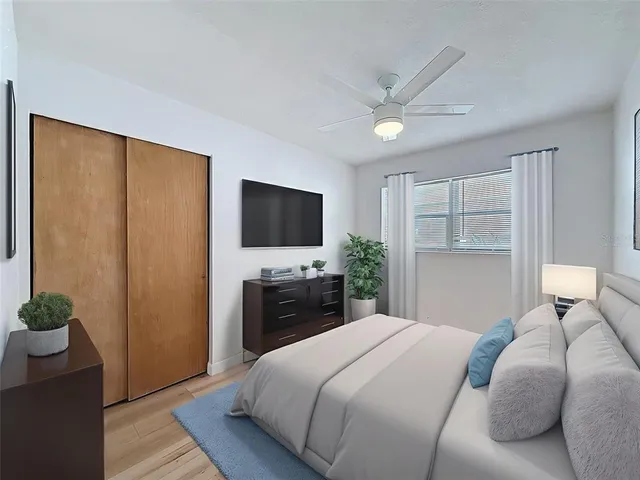 a bedroom with a large bed and a chandelier