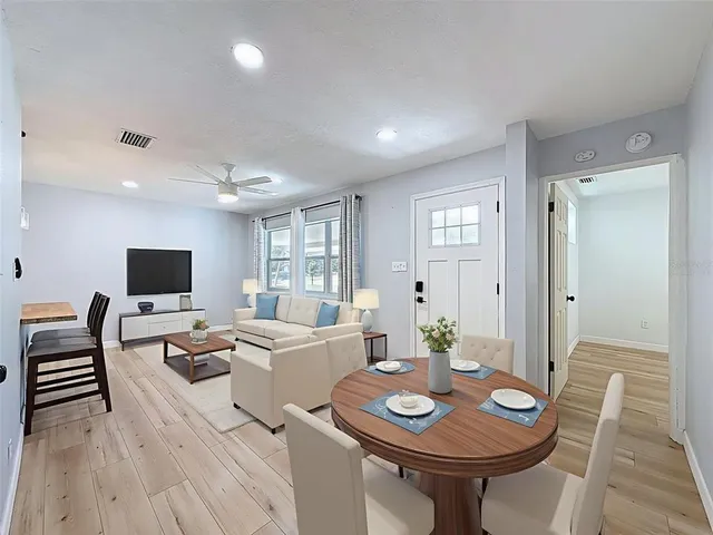 a view of a dining room with furniture and wooden floor