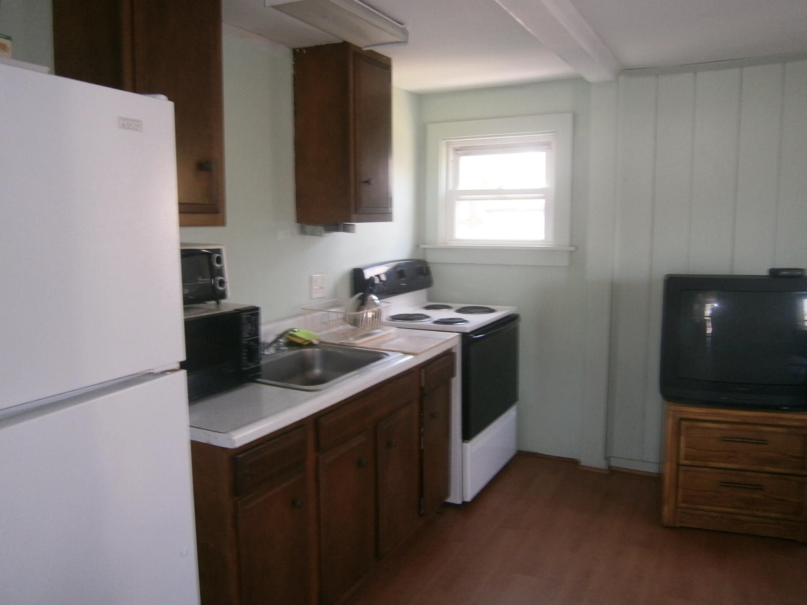 189 Captain Chase Road Dennis Port, MA 02639 - Photo 20 of 21 a kitchen with a stove and a microwave