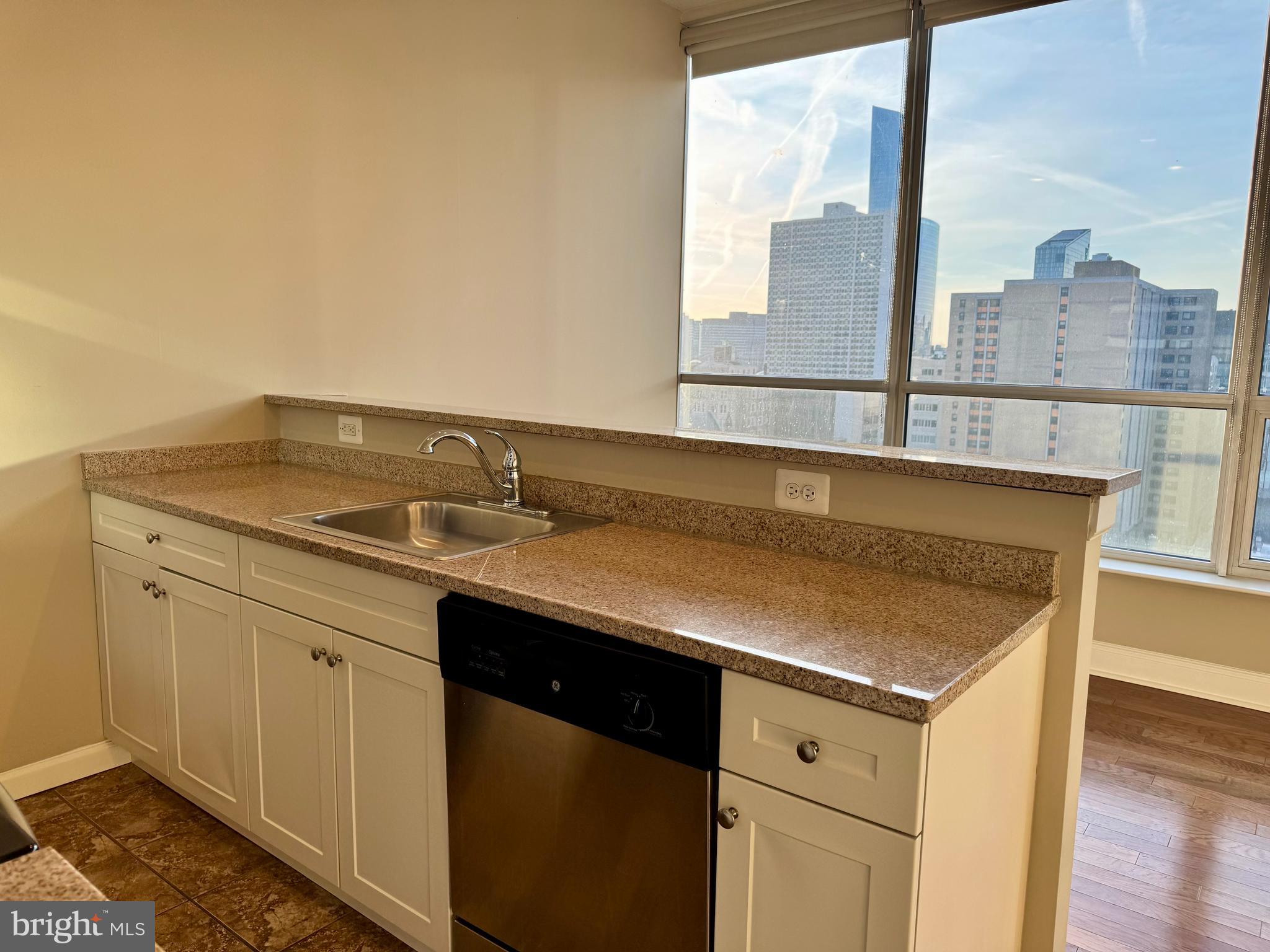 2040 Market Street, Unit 221 Philadelphia, PA 19103 - Photo 7 of 12 a view of a sink a mirror and cabinets