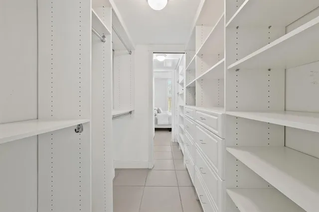 a view of a kitchen with white cabinets