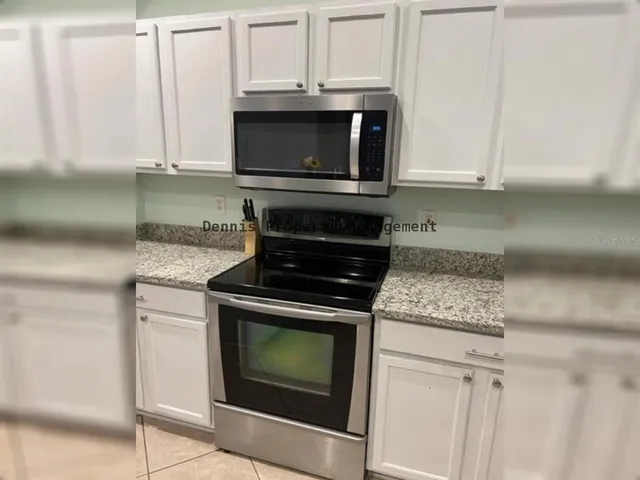 a spacious bedroom with a bed and wooden floor