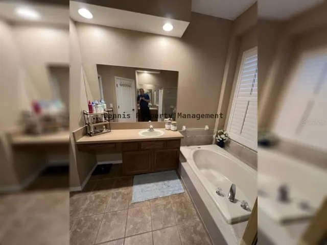 a bath tub sitting in a bathroom next to a window