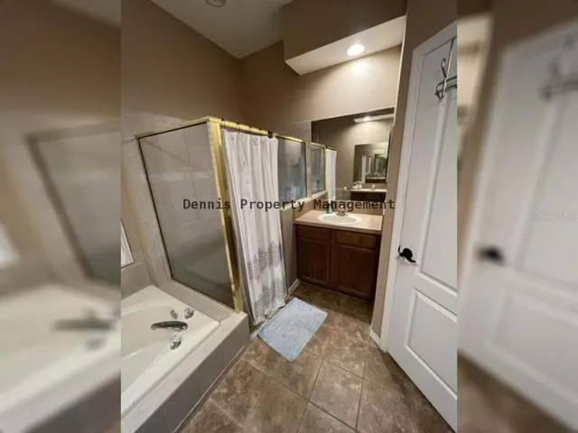 a view of a livingroom with a chandelier fan and a window