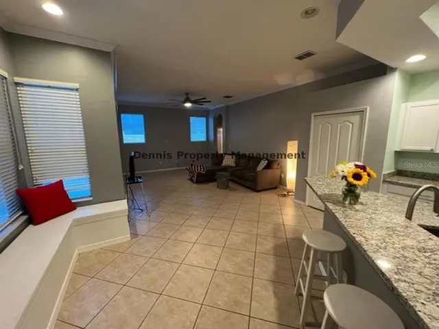 a kitchen with granite countertop a sink and refrigerator
