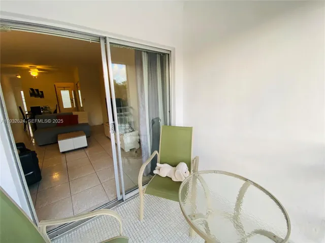 a balcony with table and chairs