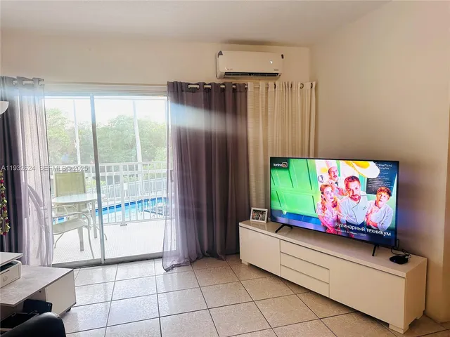 a view of room with window and refrigerator