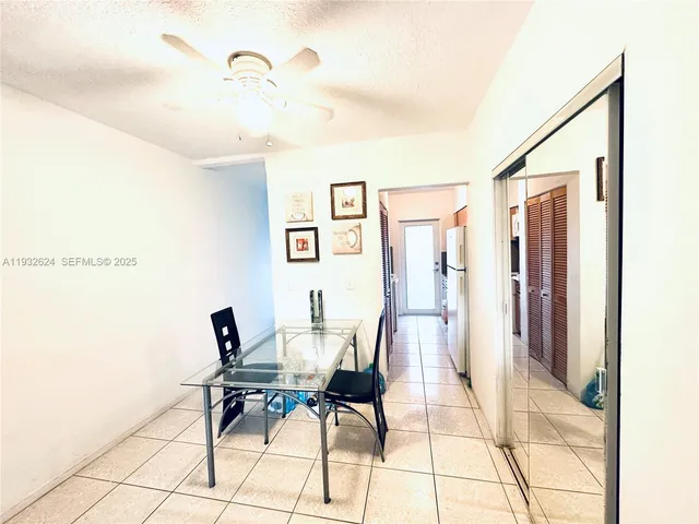 a kitchen with a sink a refrigerator and cabinets