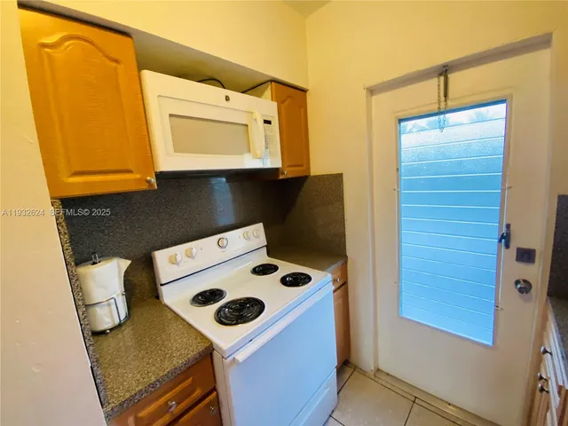a kitchen with stainless steel appliances a refrigerator and a stove