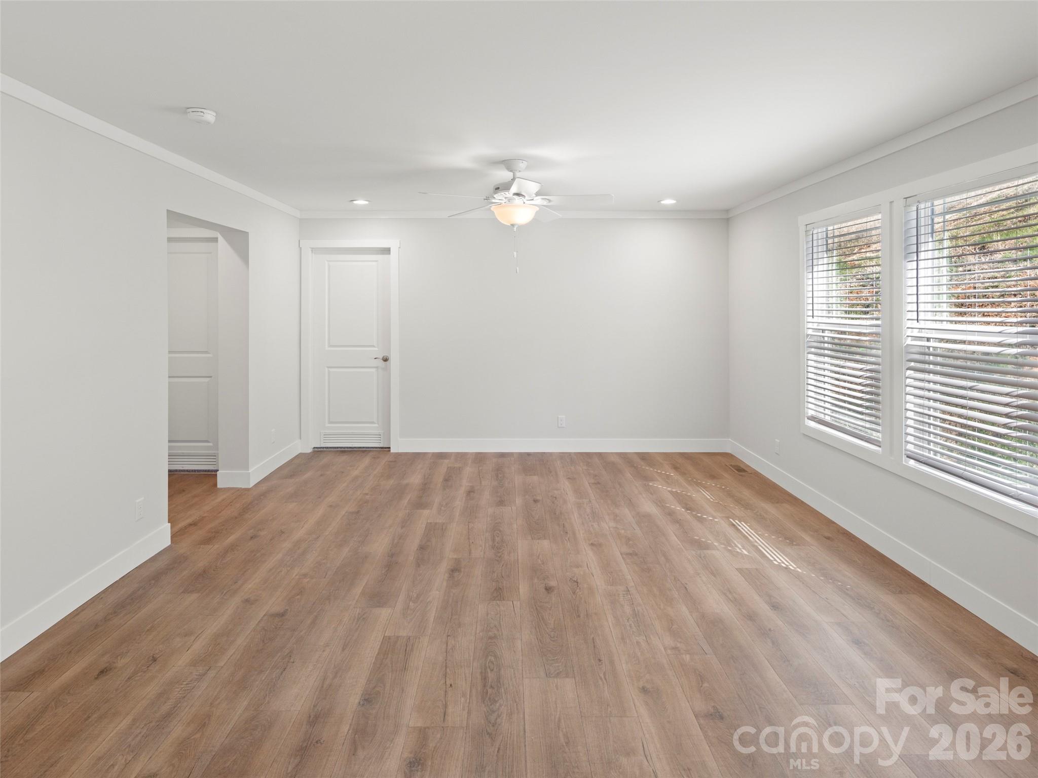 502 Hutch Mountain Road Fletcher, NC 28732 - Photo 12 of 26 wooden floor in an empty room with a window