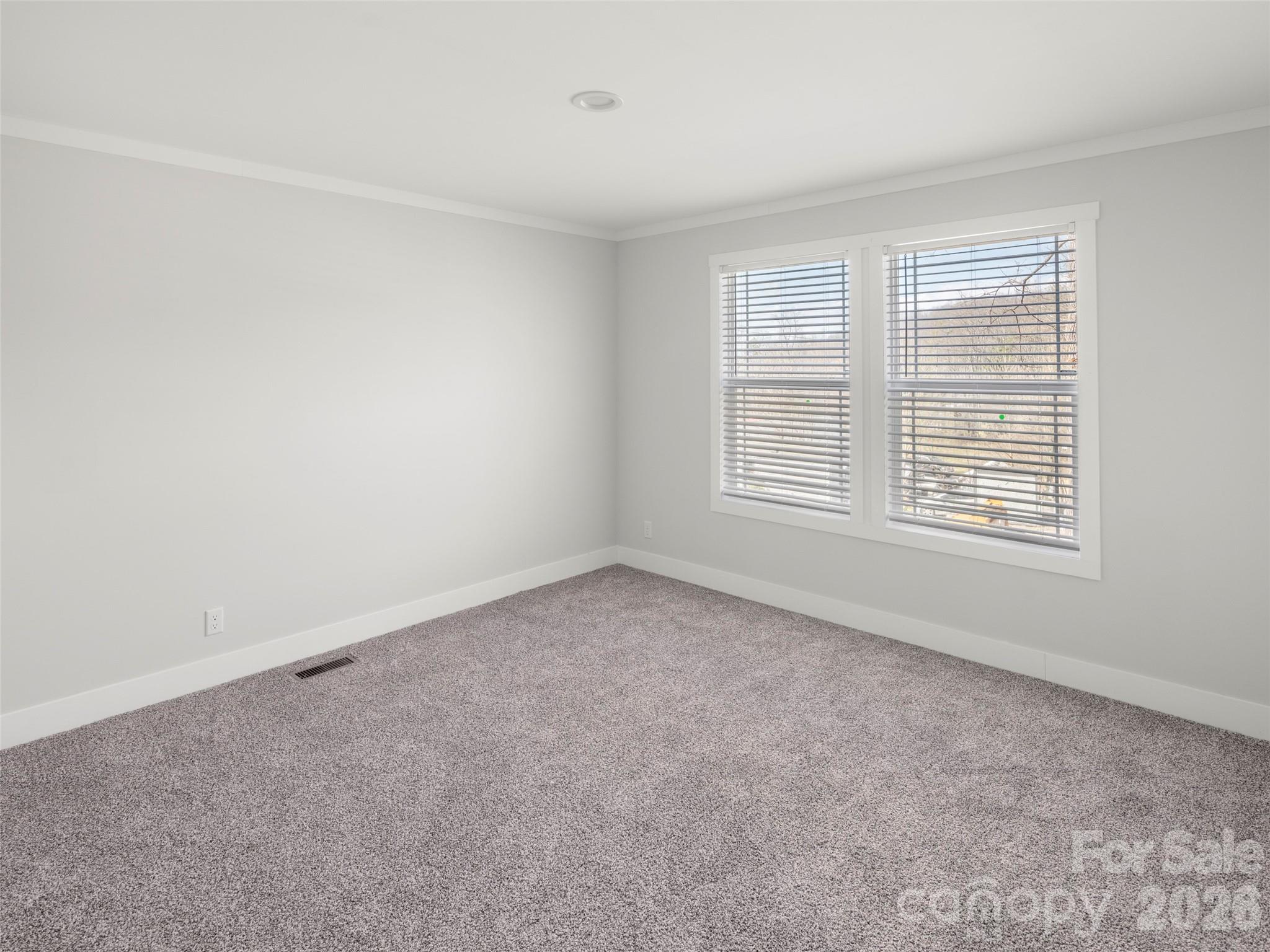 502 Hutch Mountain Road Fletcher, NC 28732 - Photo 21 of 26 an empty room with a window
