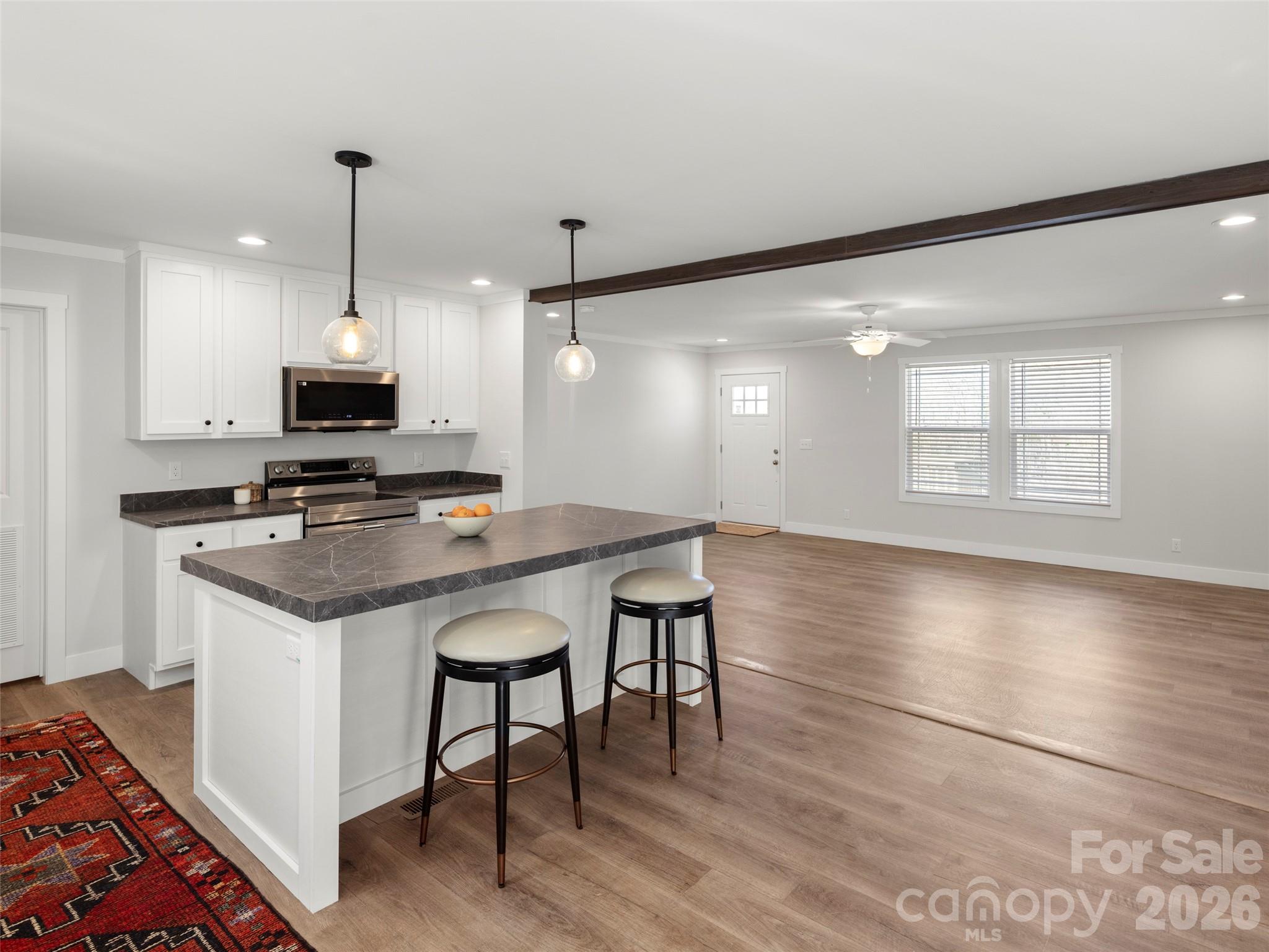 502 Hutch Mountain Road Fletcher, NC 28732 - Photo 3 of 26 a kitchen with stainless steel appliances granite countertop a stove and a refrigerator