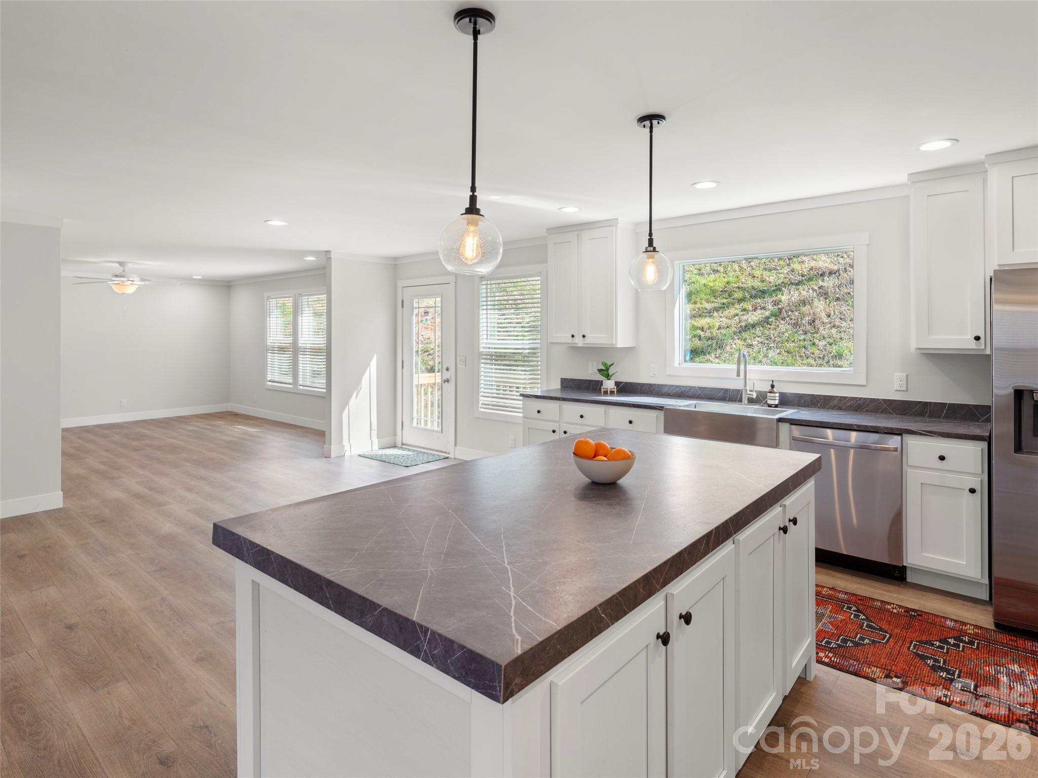 502 Hutch Mountain Road Fletcher, NC 28732 - Photo 6 of 26 a kitchen with stainless steel appliances granite countertop a sink a window and chairs