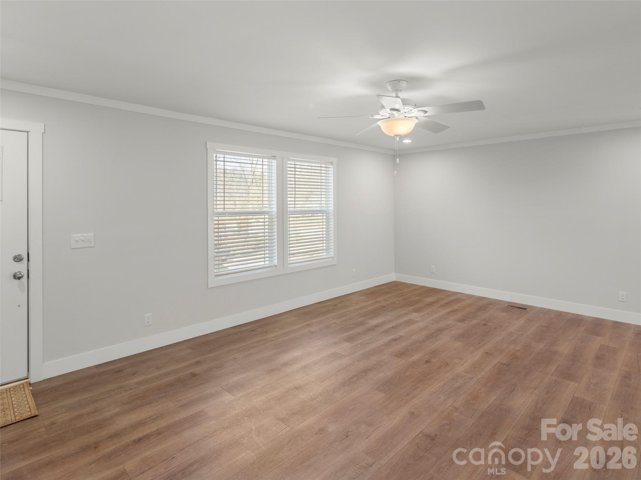 502 Hutch Mountain Road Fletcher, NC 28732 - Photo 9 of 26 wooden floor in an empty room with a window